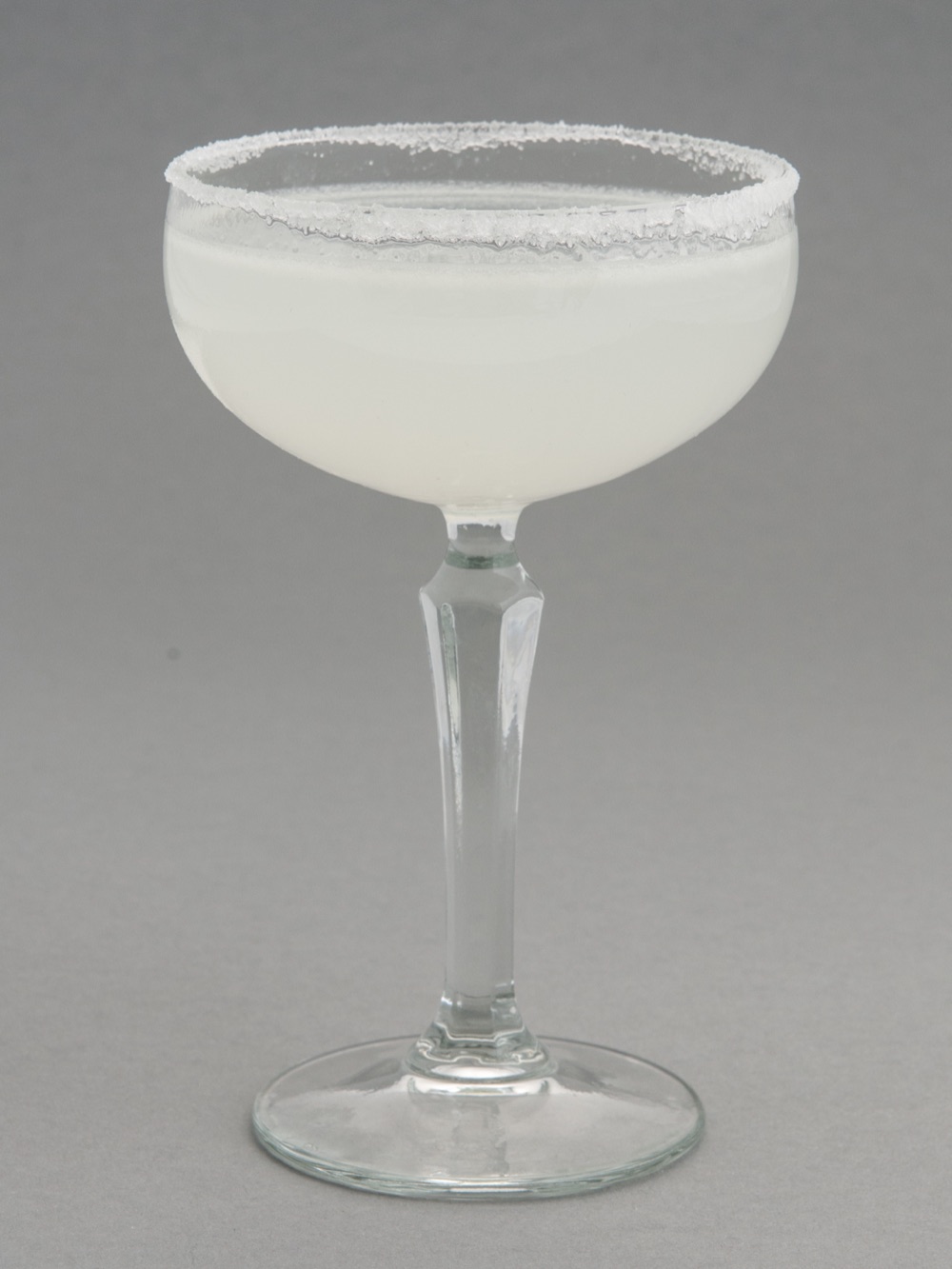 A margarita with a salt rim and a lime wheel